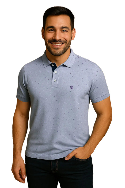 Modelo con polo Dubrovnik azul cielo que presenta un micropatrón de puntos, carterita interna en azul marino y escudo bordado circular